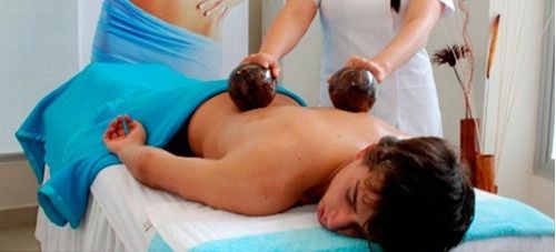 Man getting a coconut therapeutic massage