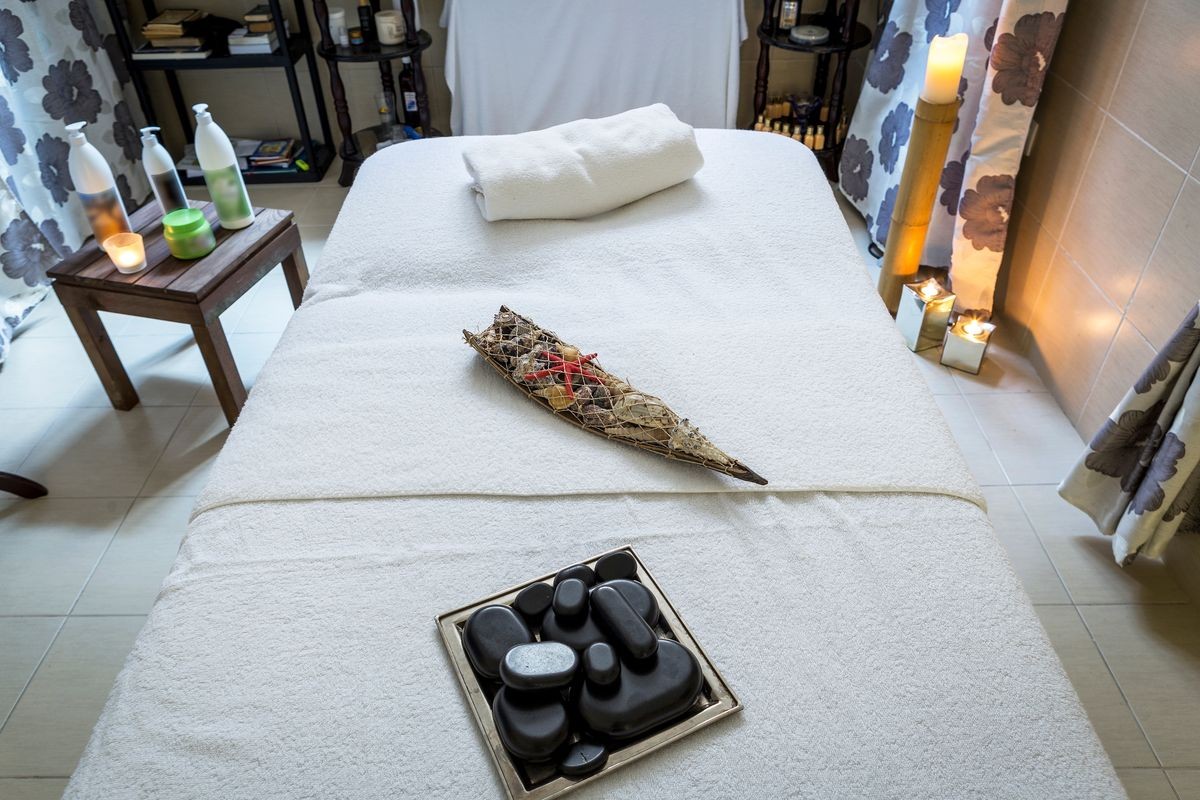 a massage room and spa treatments.free and empty room for massages and recovery of patients. a table with towels, aromatic candles,volcanic stones and everything needed for a complete and good massage