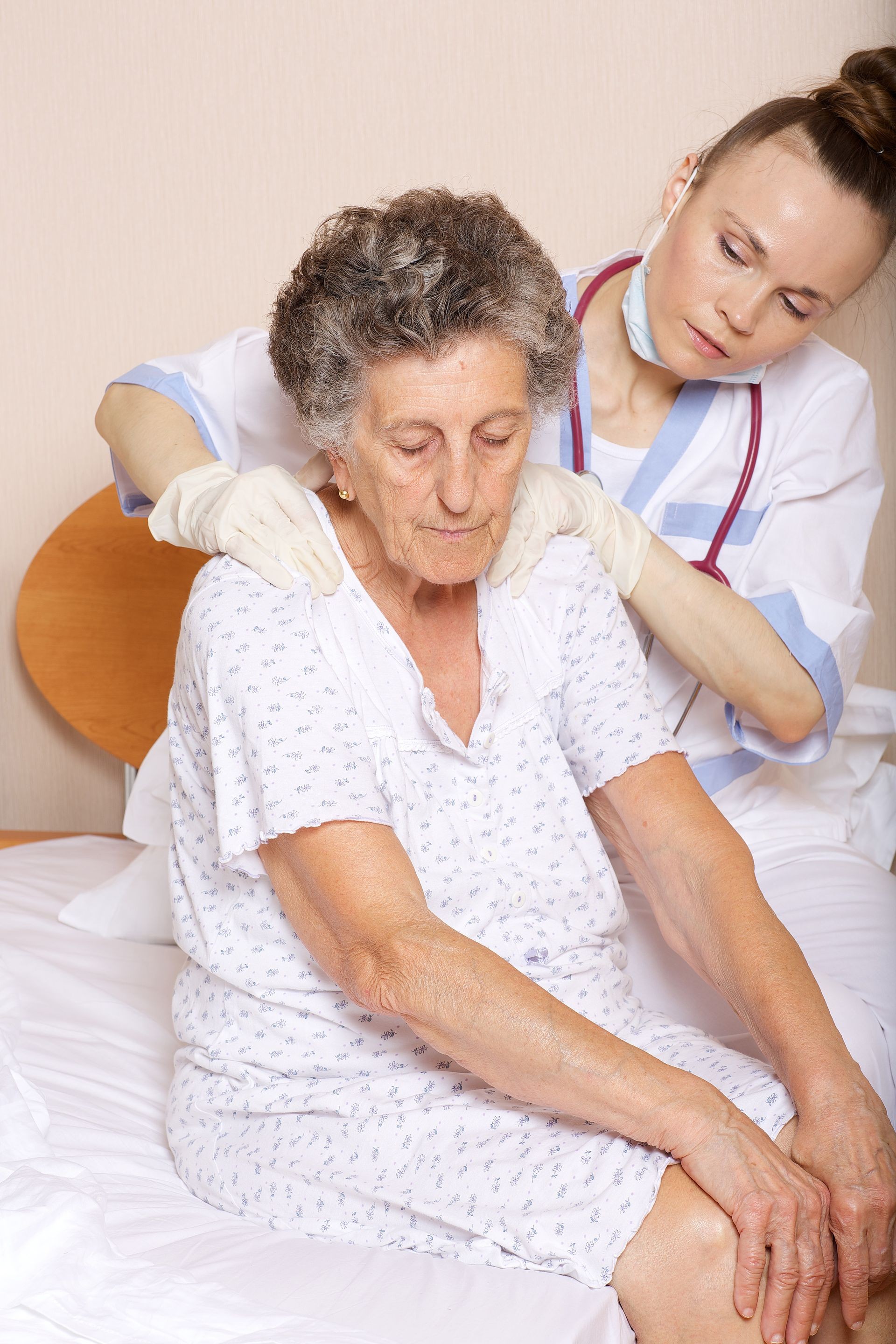 Geriatrician visits a senior woman between 70 and 80 years old in her ward